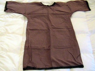 A golden-brown tunic, with roman-style trim