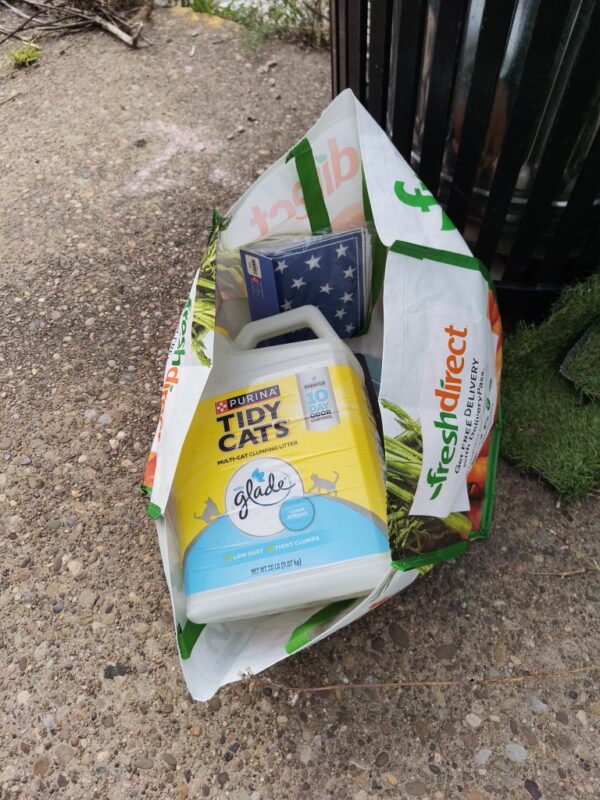 A bag containg kitty litter and patriotic napkins in Garfield