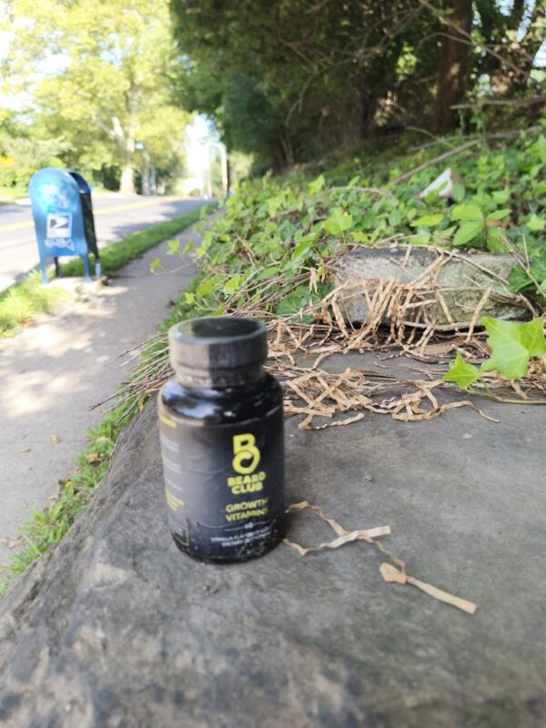 A sealed bottle of beard vitamins rests on a plinth in North Squirrel Hil