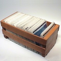 A wooden CD storage crate full of CD sleeves