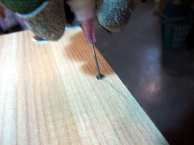 Dribbling glue into a peg hole.