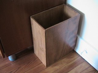 A wastebasket made of wood